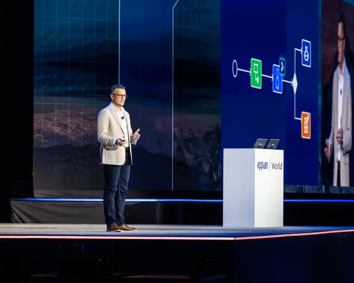 Matt Calkins speaking on stage about Agentic AI and enterprise orchestration at Appian World 2026.