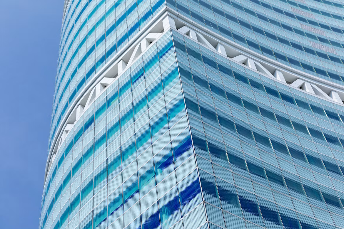 Blue glass office tower seen from below, illustrating enterprise architecture and SAP S/4HANA transformation in APAC.